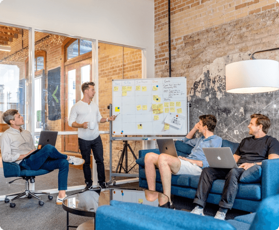 Source Code engineers planning a sprint at a whiteboard
